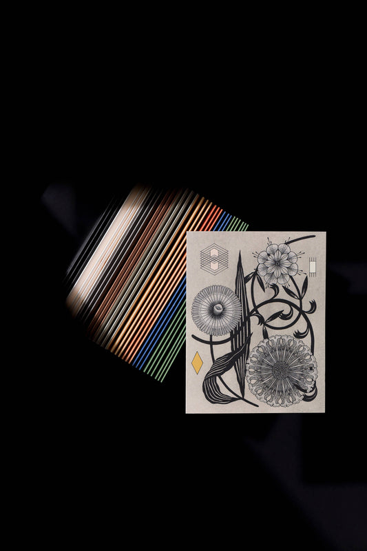 Stylized photo over a textured background, of a gray card with geometric symbols and flowers on it