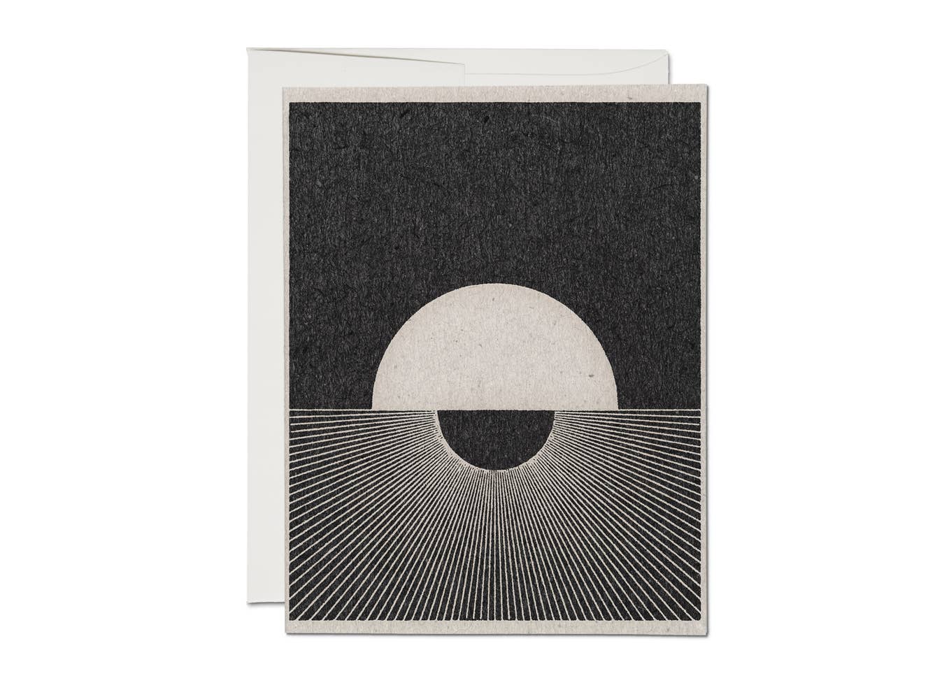Greeting card with a minimalist ink design of a moon and sun on a textured white background