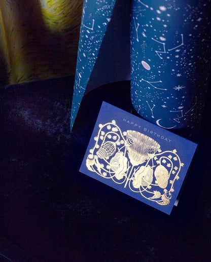 Blue birthday card with gold design on a dark background