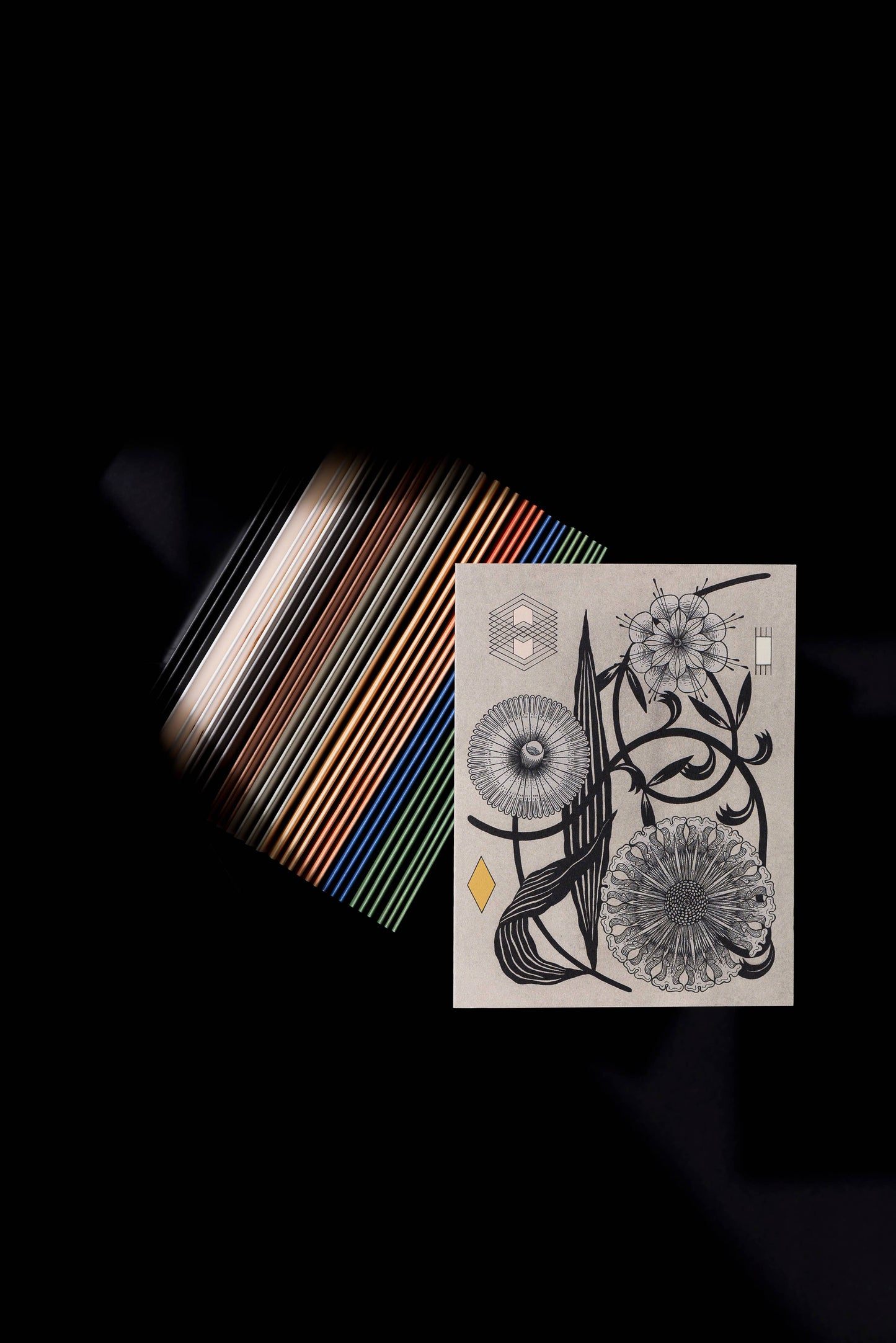 Stylized photo over a textured background, of a gray card with geometric symbols and flowers on it