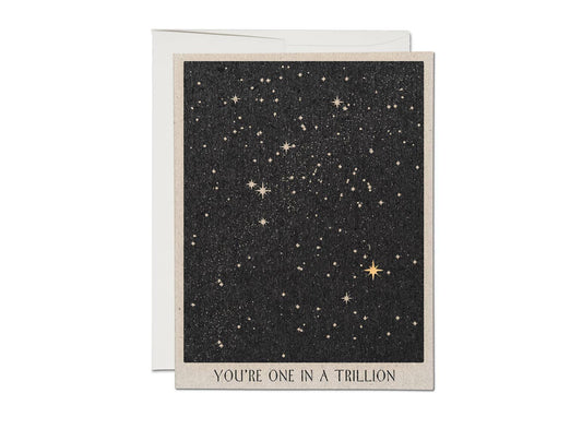 Minimalist black ink card with starry night design and 'You're one in a trillion' text on natural white paper